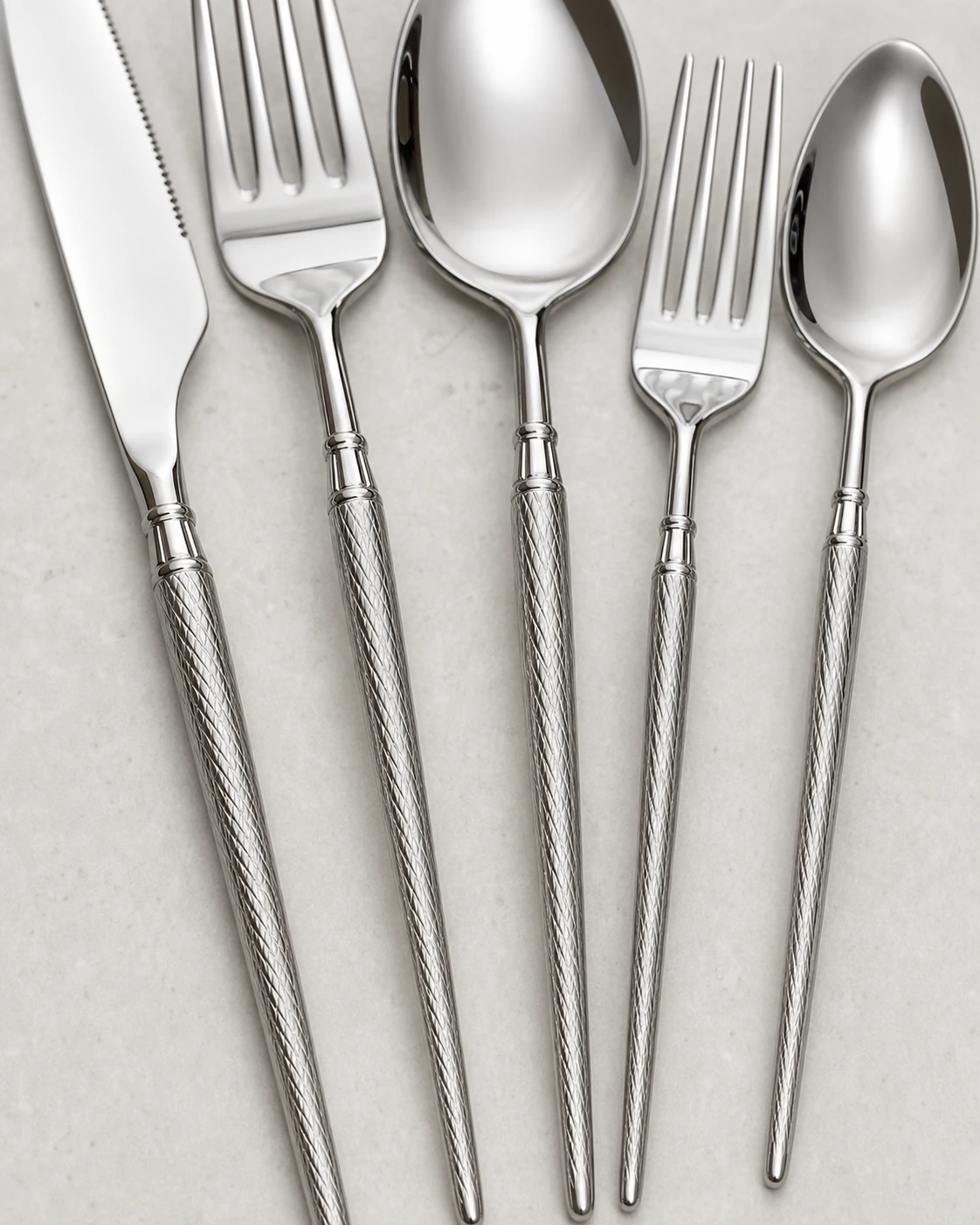 Close view of engraved lattice handles and polished silver collars