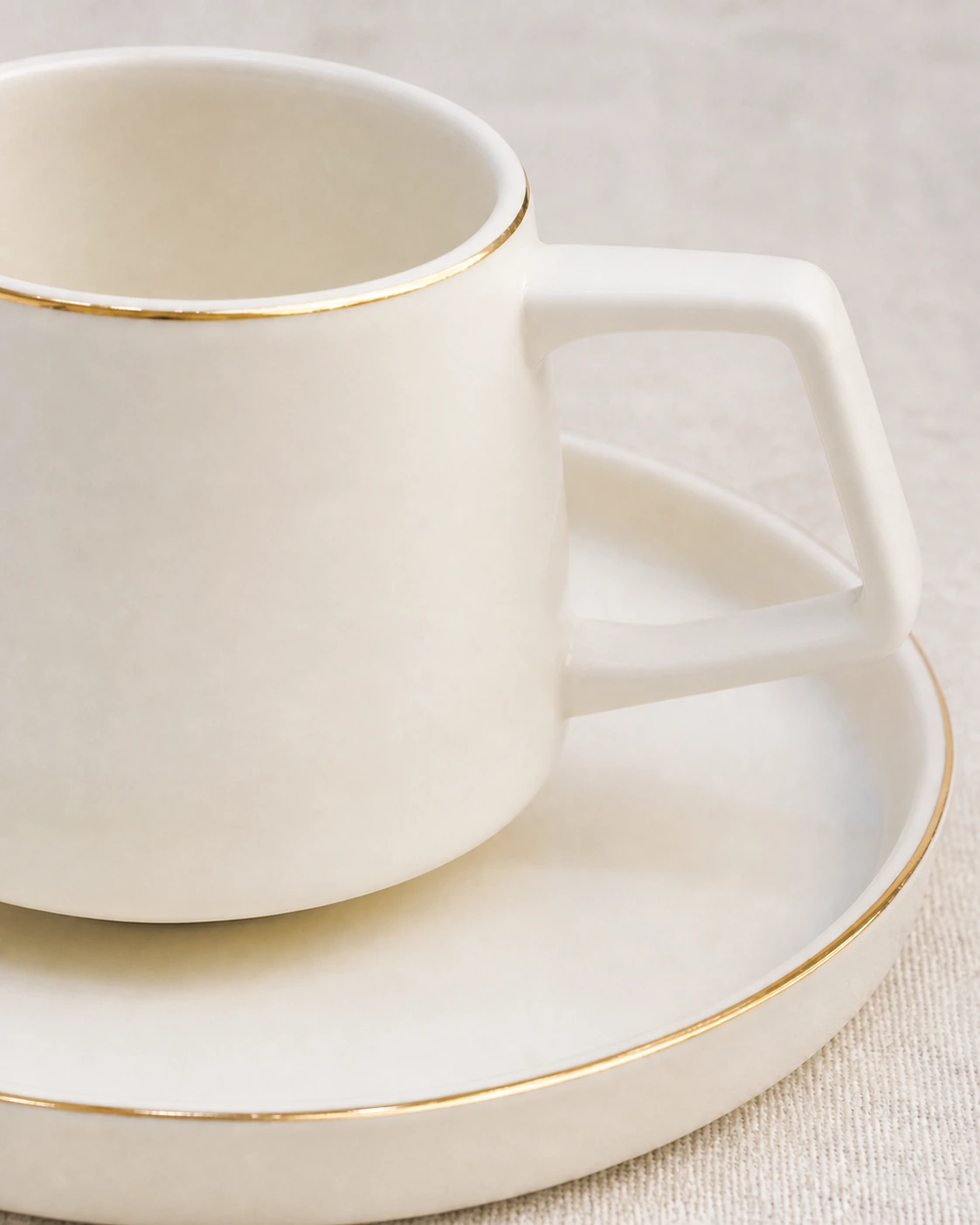 Close view of Linea plain angular ceramic handle and fine antique gold rims