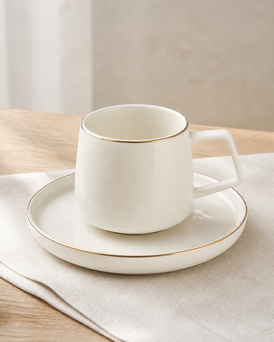 Linea ivory angular handle cup and saucer on natural linen