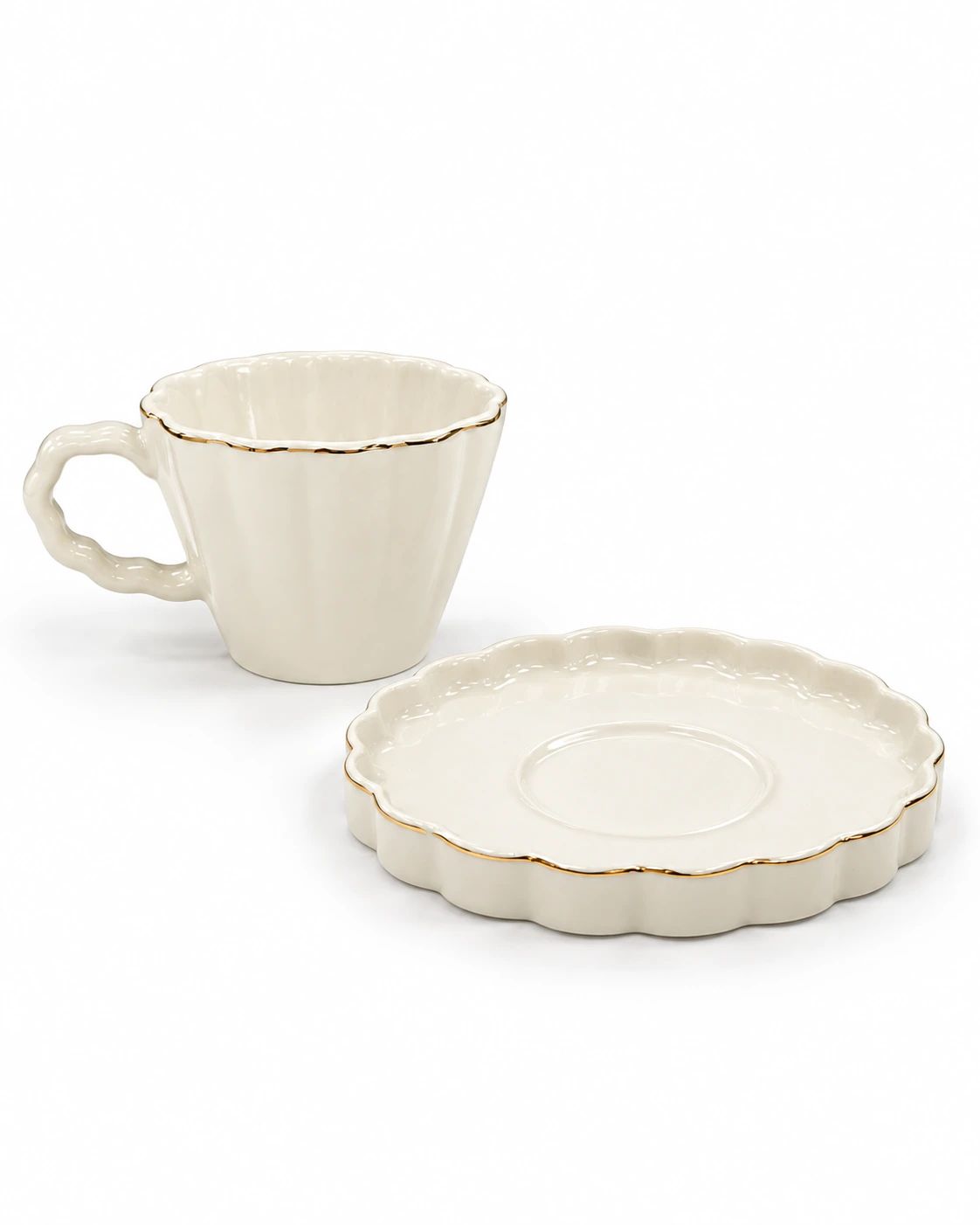 White porcelain cup and saucer with scalloped edges and gold-coloured trim