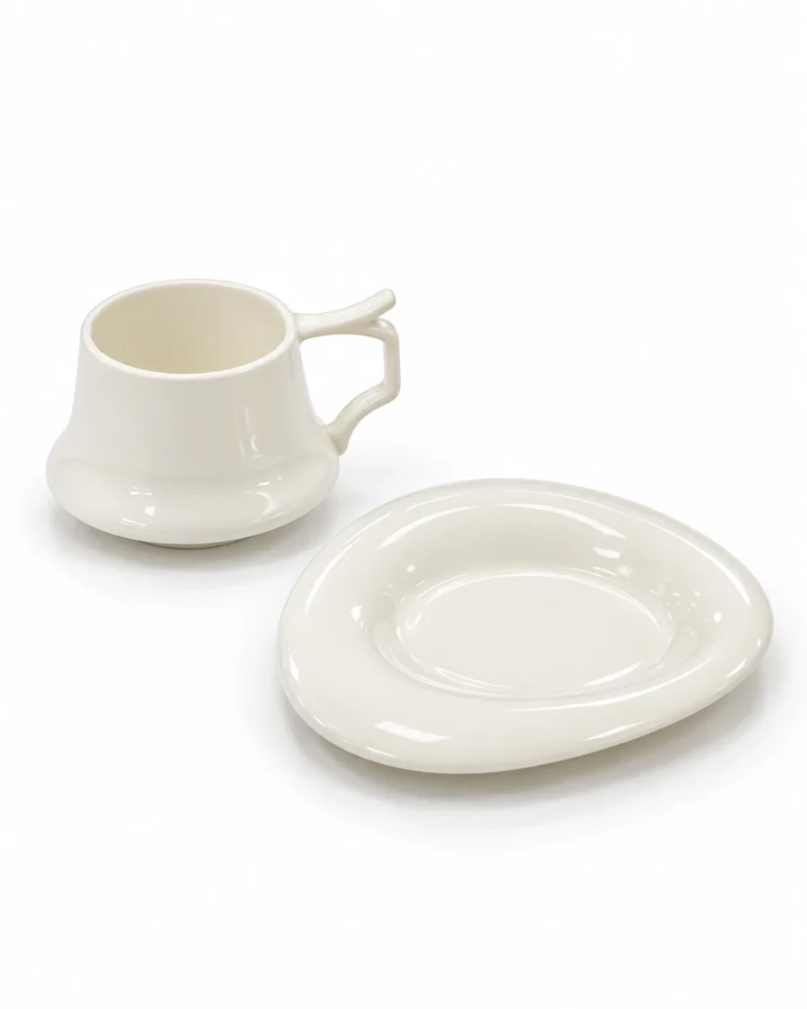 Ivory porcelain cup with an angular handle and matching shaped saucer