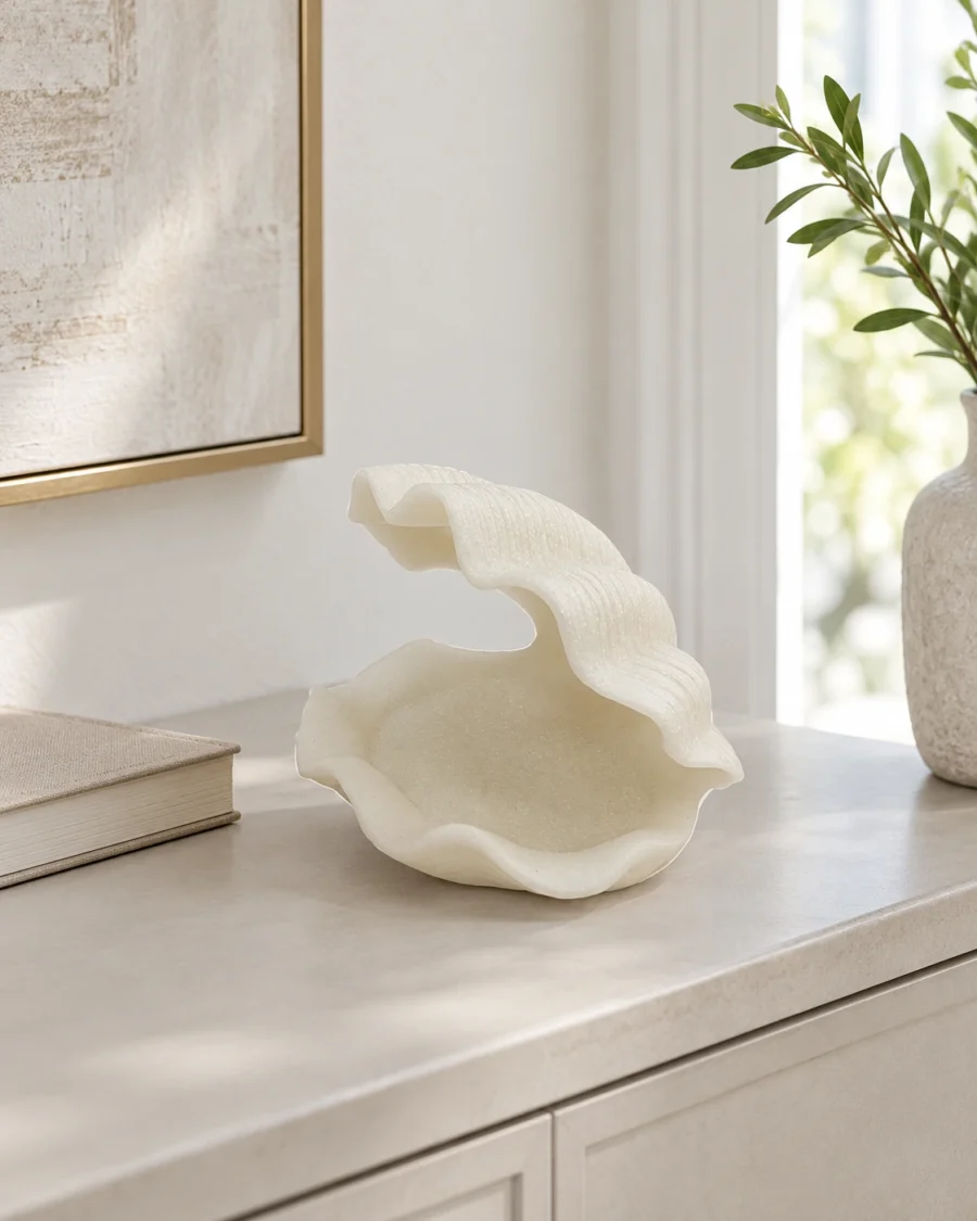 Small ivory polyresin decoration with a sculpted shell shape in a bright interior