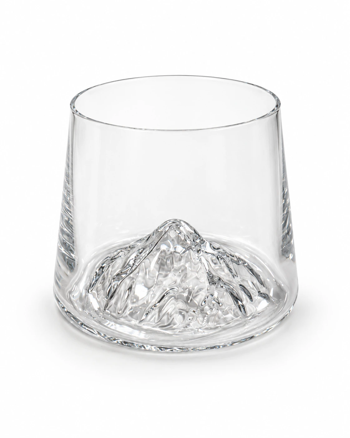Clear glass tumbler with a raised mountain-shaped base