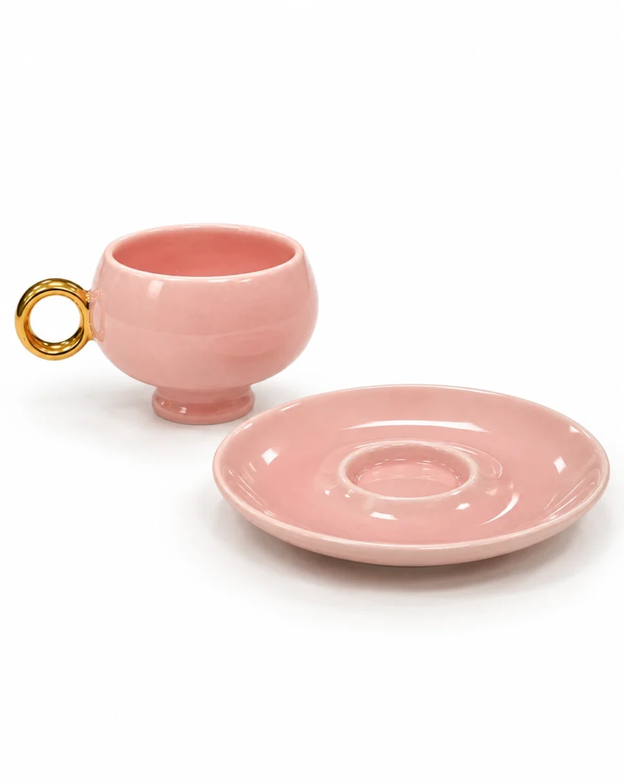 Pink porcelain cup and saucer with a gold-coloured ring handle