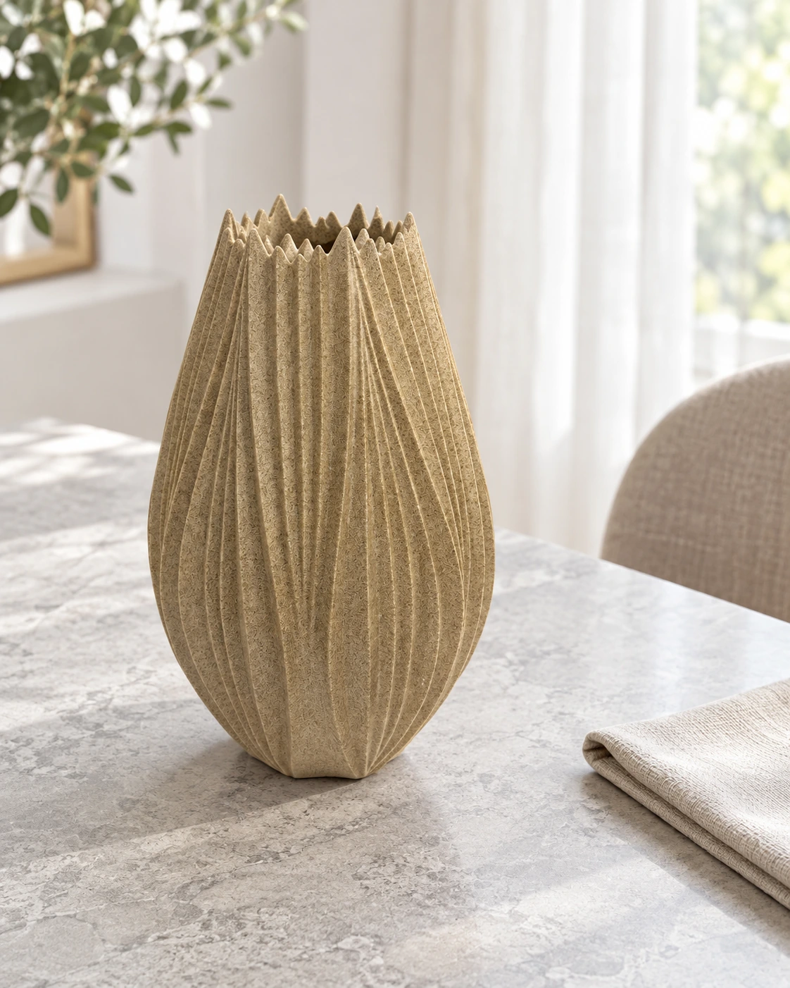 Sand-coloured polyresin vase with a ribbed surface in a bright interior
