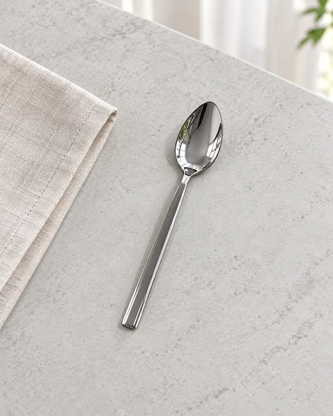 Stainless steel tea spoons with oval bowls in a bright interior